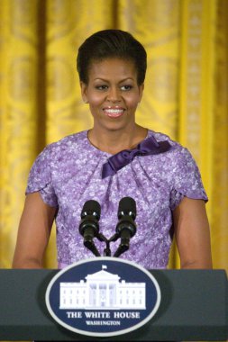 Michelle Obama (wearing an Anne Klein New York dress) at a public appearance for Afternoon Tea Honoring Women in the Military, East Room of the White House, Washington DC, DC November 18, 2009. Photo By: Stephen Boitano/Everett Collection