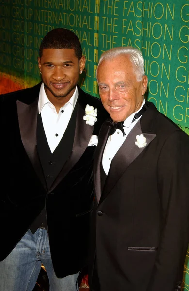 Usher and Giorgio Armani at The Conceptualist Fashion Group INTERNATIONAL 21ST ANNUAL NIGHT OF STARS at Cipriani's, NY, October 28, 2004. (Photo by David Blackman/Everett Collection)
