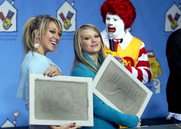 Haylie and HiIlary Duff hold handprints off themselves at the MCDONALD'S WORLD CHILDREN'S DAY KICK OFF in Los Angeles, California, November 9, 2004