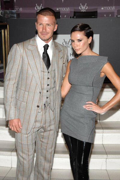 David Beckham (wearing a Tom Ford suit), Victoria Beckham (wearing Antonio Berardi) at in-store appearance for Beckham Signature Fragrance Exclusive Launch, Macy 's Herald Square, New York, NY, September 26, 2008. Фото: Lee / Everett Collection
