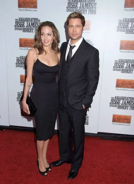 Angelina Jolie (wearing a vintage Hermes dress), Brad Pitt