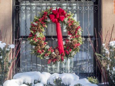 Noel tatili ve kar fırtınası penceresinde üzerinde çelenk