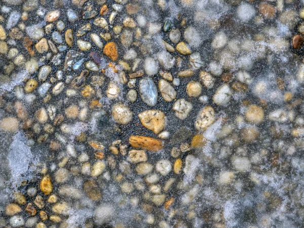 Sidewalk of pebbles with ice — Stock Photo, Image