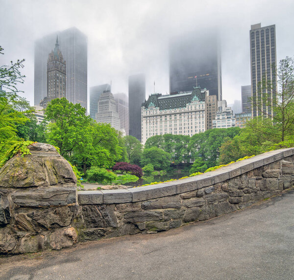 Gapstow Bridge in Central Park in late spring on foggy day in the early morning