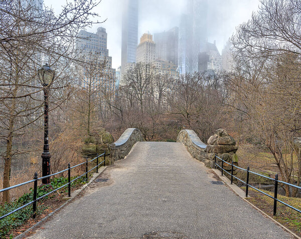 Gapstow Bridge in Central Park on foggy morning in winter