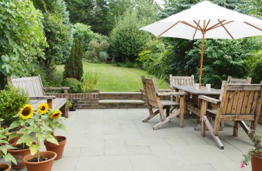 Patio with garden furniture and parasol clipart