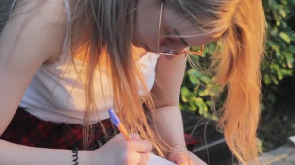 Girl Writes Notebook Homework Park — Stock Video