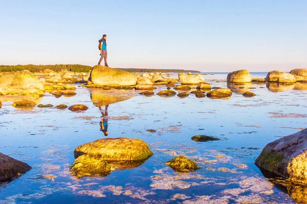 man stands on a stony coastline at dawn inspiring by life