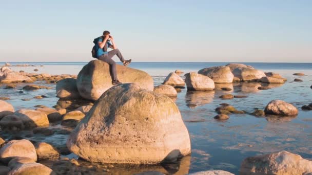 Assentos Fotógrafo Uma Costa Pedregosa Amanhecer Inspirador Pelo Conceito Liberdade — Vídeo de Stock