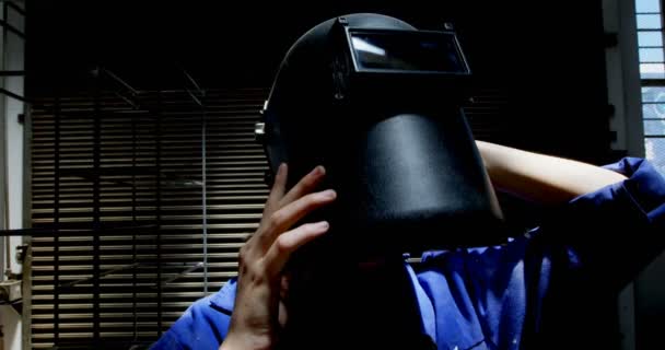 ワーク ショップ で溶接のヘルメット身に着けている女性の溶接機 — ストック動画