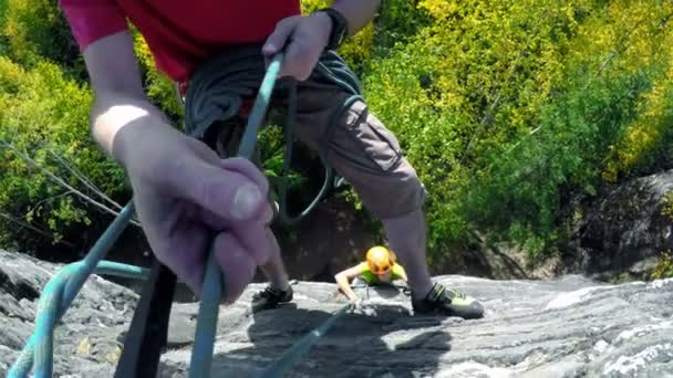 Close Van Bergbeklimmers Klimtouw Aanpassen Tijdens Het Klimmen Van Klif — Stockvideo