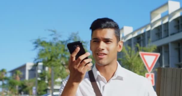 Hombre Hablando Por Teléfono Móvil Mientras Camina Por Calle Ciudad — Vídeo de stock