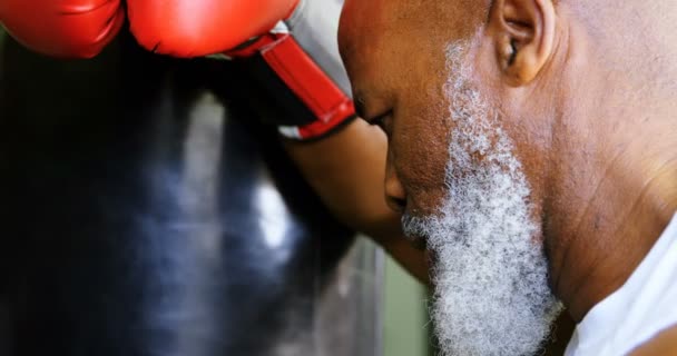 Close Tired Senior Boxer Leaning Punching Bag — Stock Video