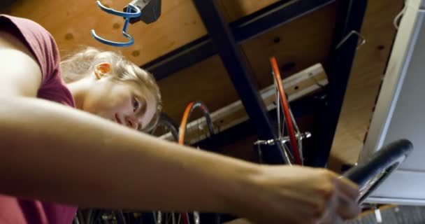 Beautiful Woman Checking Bicycle Tyre Workshop — Stock Video