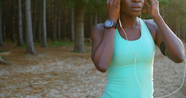 Young Female Athlete Listening Music While Exercising Forest — Stock Video