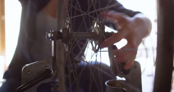 Woman Repairing Checking Bicycle Workshop — Stock Video