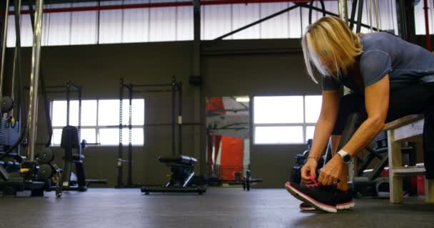 Disabled Senior Woman Tying Shoelace Fitness Studio — Stock Video