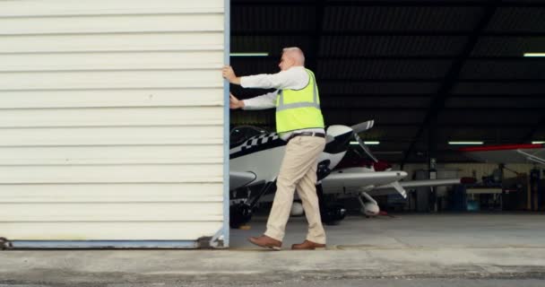 Male Engineer Opening Shutter Aerospace Hangar — Stock Video