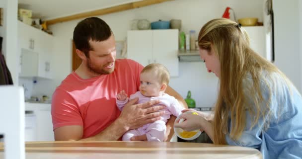 Parents Feeding Baby Home — Stock Video