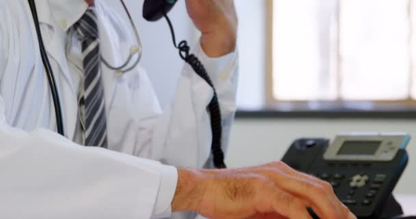 Close Physician Using Laptop While Talking Landline Desk Clinic — Stock Video