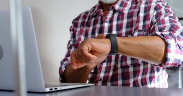 Senior Male Executive Using Smartwatch While Working Laptop Office — Stock Video