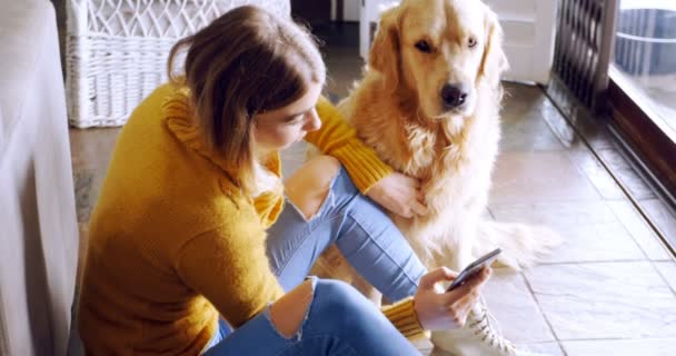 Women Using Mobile Phone Her Dog Home — Stock Video