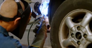 Bir araba tamir Garage 4 k wielding meşale kullanarak makinist
