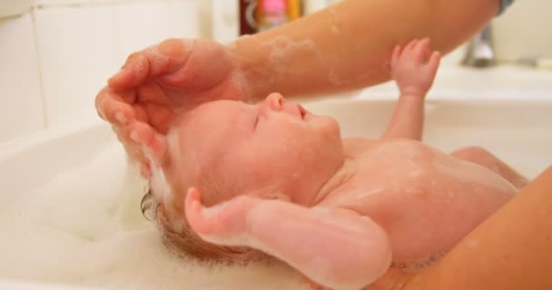 Close Mother Giving Her Baby Boy Bath Bathroom Home — Stock Video