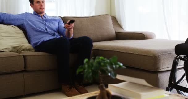 Disabled Man Watching Television Sofa Home — Stock Video