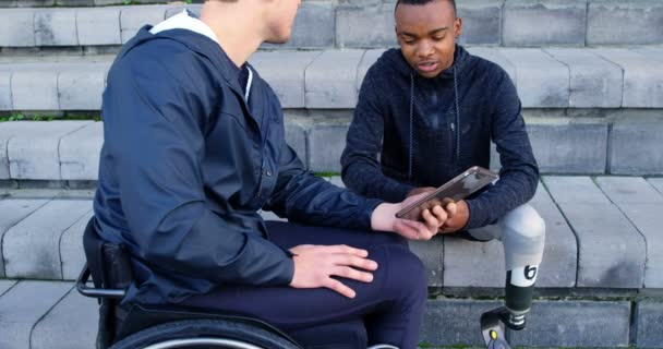 Deux Athlètes Handicapés Discutent Sur Tablette Numérique Sur Site Sportif — Video