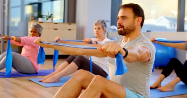 Trainer Assisting Senior Women Performing Yoga Yoga Center — Stock Video