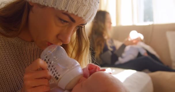 Lesbian Couple Feeding Milk Babies Home — Stock Video