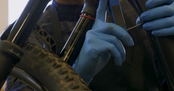 Attentive Man Repairing Bicycle Workshop — Stock Video