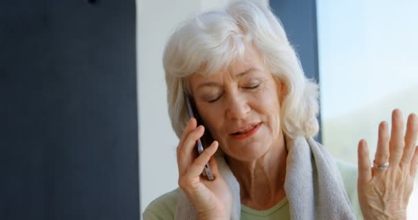 Senior Woman Talking Mobile Phone Yoga Center — Stock Video