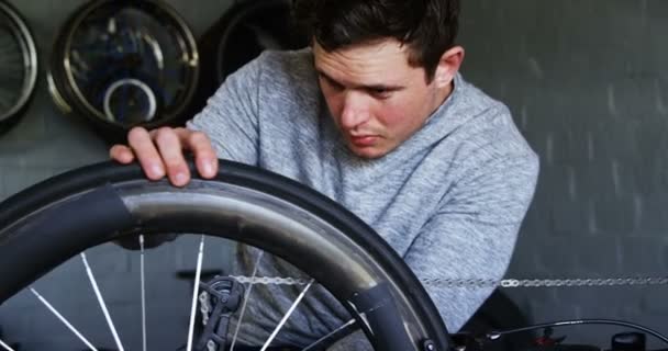 Young Disabled Man Repairing Wheelchair Workshop — Stock Video