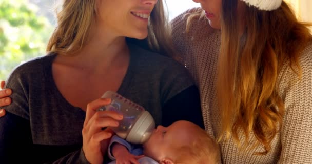 Lesbian Couple Feeding Milk Baby Home — Stock Video