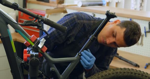 Attentive Man Repairing Bicycle Workshop — Stock Video