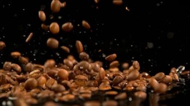 Kavrulmuş kahve çekirdekleri su siyah arka plan 4 k karşı düşen