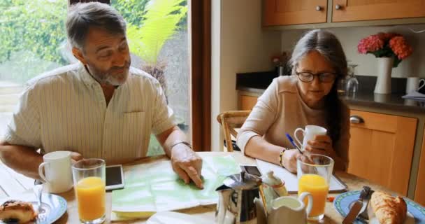 Active Senior Couple Calculating Invoices Home — Stock Video