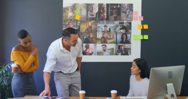 Compañeros Negocios Discutiendo Sobre Fotografías Reunión Oficina — Vídeo de stock