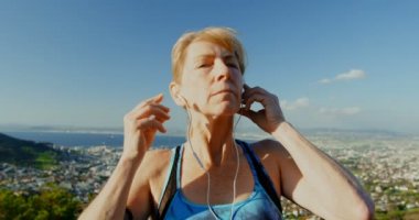 Aktif kadın kıdemli kırsal 4k kulaklıklar müzik dinleme