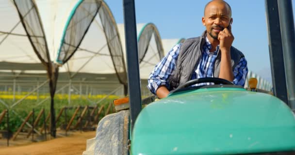 Front View Mixed Race Man Sitting Tractor Talking Mobile Phone — Stock Video