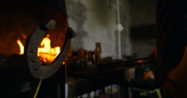 女性金属匠在火中加热马蹄铁的特写镜头 操作马蹄形的杠杆 — 图库视频影像