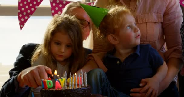 Family Celebrating Birthday Party Living Room Grandfather Lighting Candles — Stock Video