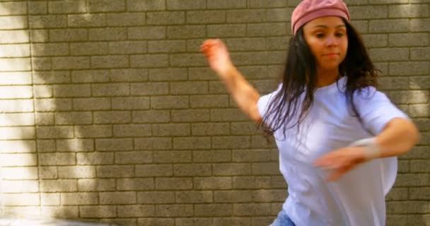 美丽的年轻舞蹈家在城市的砖墙上跳舞 在阳光明媚的日子里优雅地跳舞4K — 图库视频影像