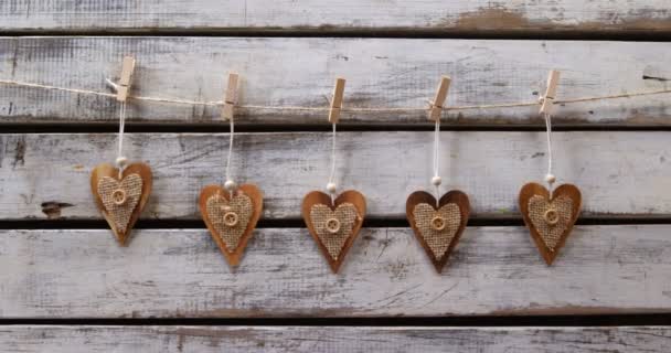 Heart Shaped Decorations Pinned Rope Wooden Wall Background — Stock Video