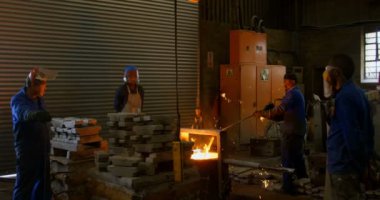 Döküm atölyesinde çalışan işçiler. Metal atölyesinde 4 k erime işçi