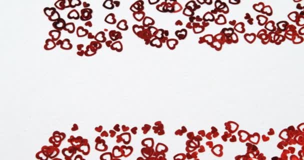 Red Heart Shape Confettis White Surface Scattered Confetti — Stock Video