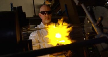 Cam üfleme cam fabrikasında olgun erkek işçi önden görünümü. Olgun erkek işçi cam 4 k Isıtma