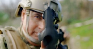 Yetişkin beyaz askeri asker tüfeği eğitim alanında eğitim sırasında önden görünümü. O tüfek alanda 4 k hedefliyor